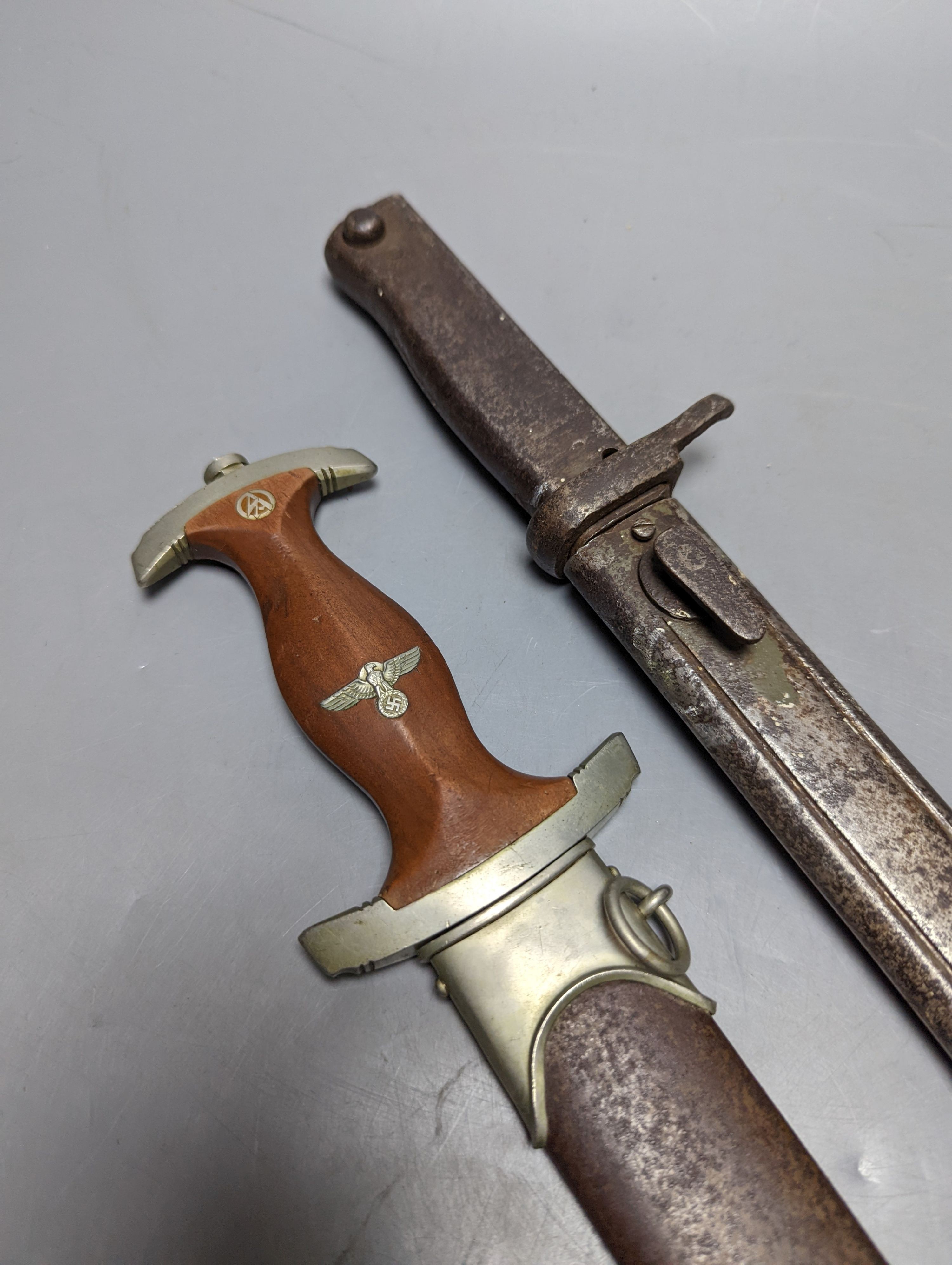 A Third Reich SA dagger within sheath, blade 22cm., and a bayonet within scabbard